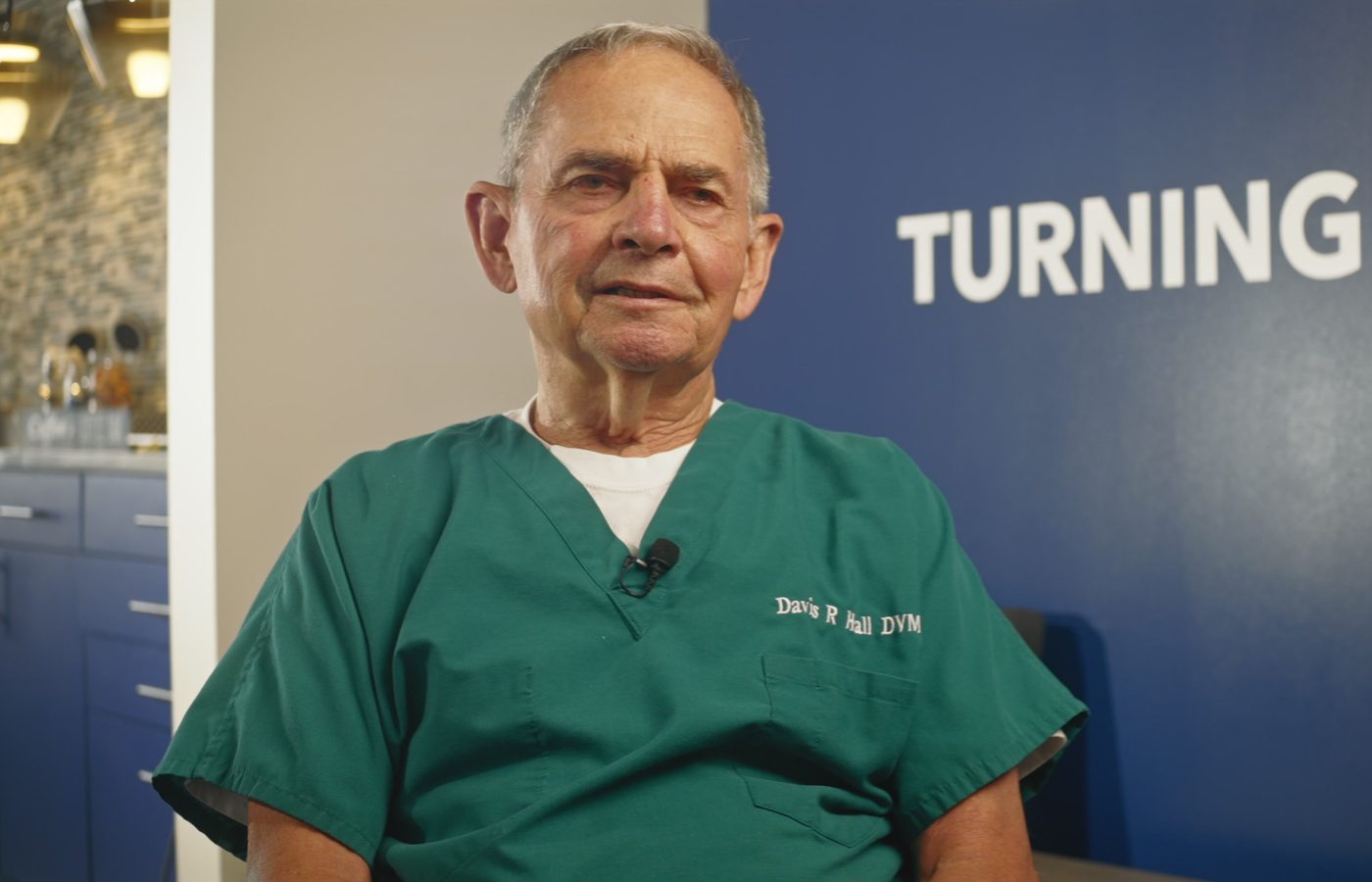 Dr. Davis Hall, founder of Town and Country Animal Hospital, in green scrubs