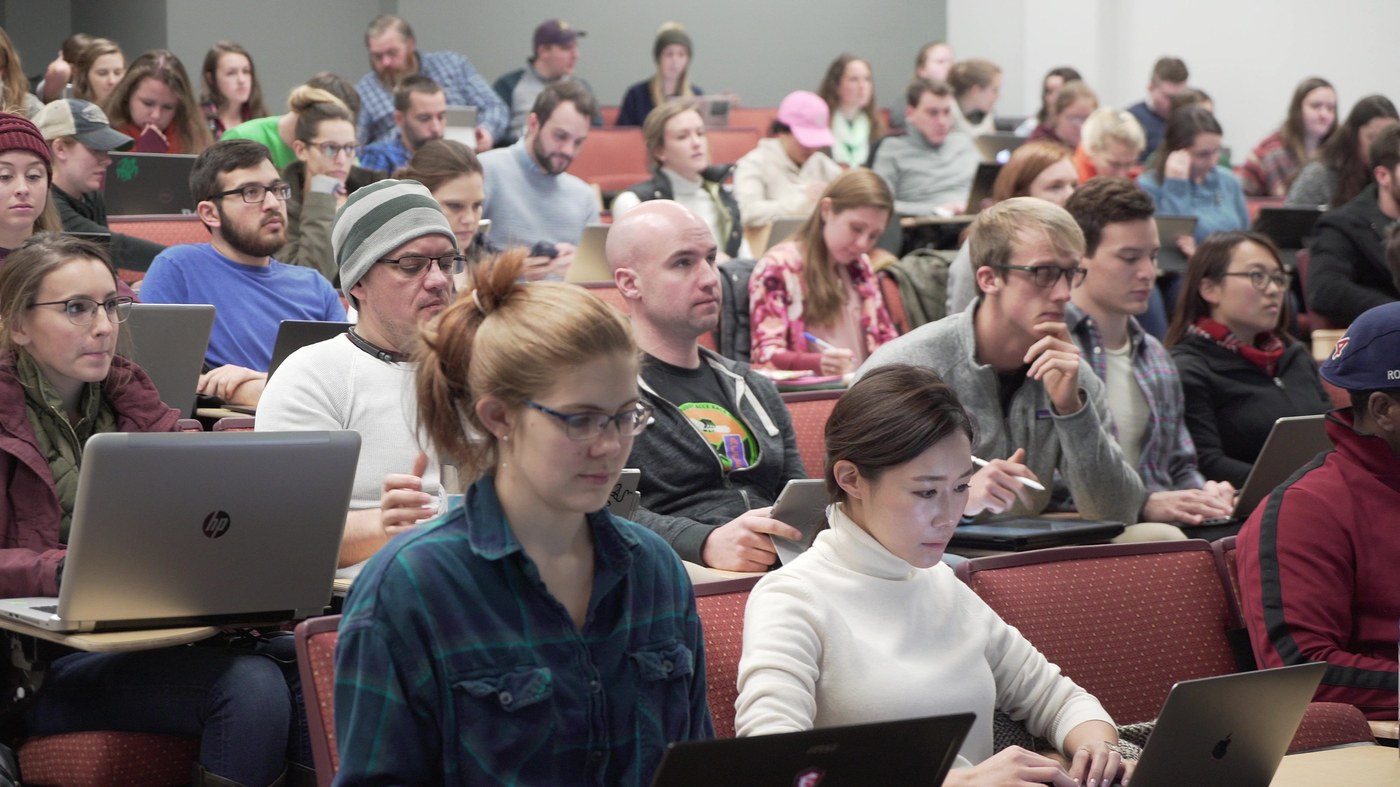Veterinary students taking notes in a packed lecture hall at the Virginia-Maryland College of Veterinary Medicine
