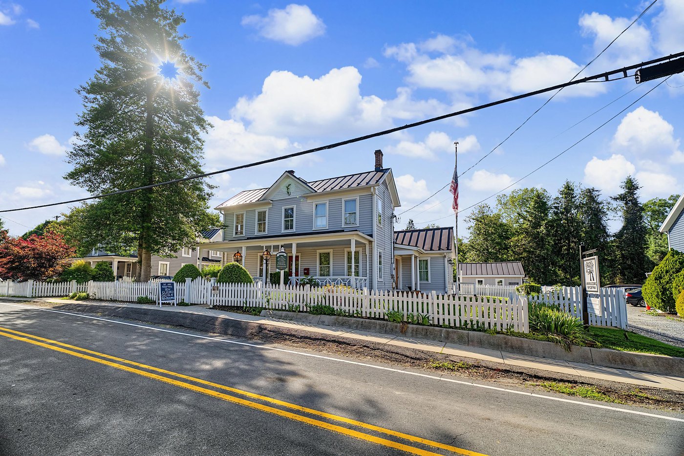 A house behind a white picket fence on Chapel Road, home of Animal Clinic of Clifton